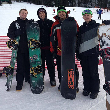 A picture of my two brothers, my friend, and I, in Tahoe at Squaw Valley Ski Resort. We are in full snowboard gear.